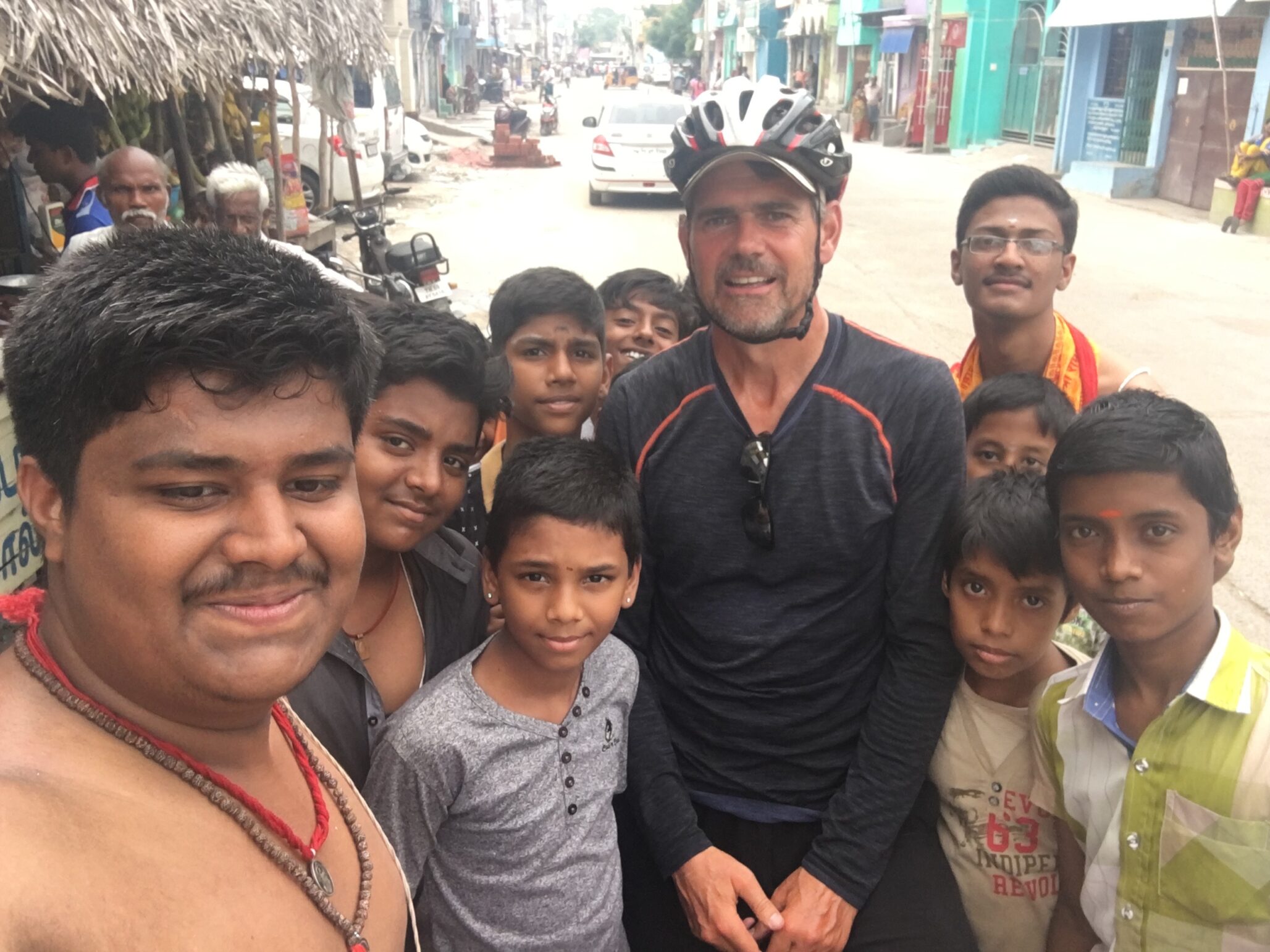 Mark with a group of local residents in a city street