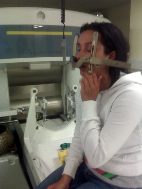 Lisa Connell sits on a scanning machine with a metal device around her head