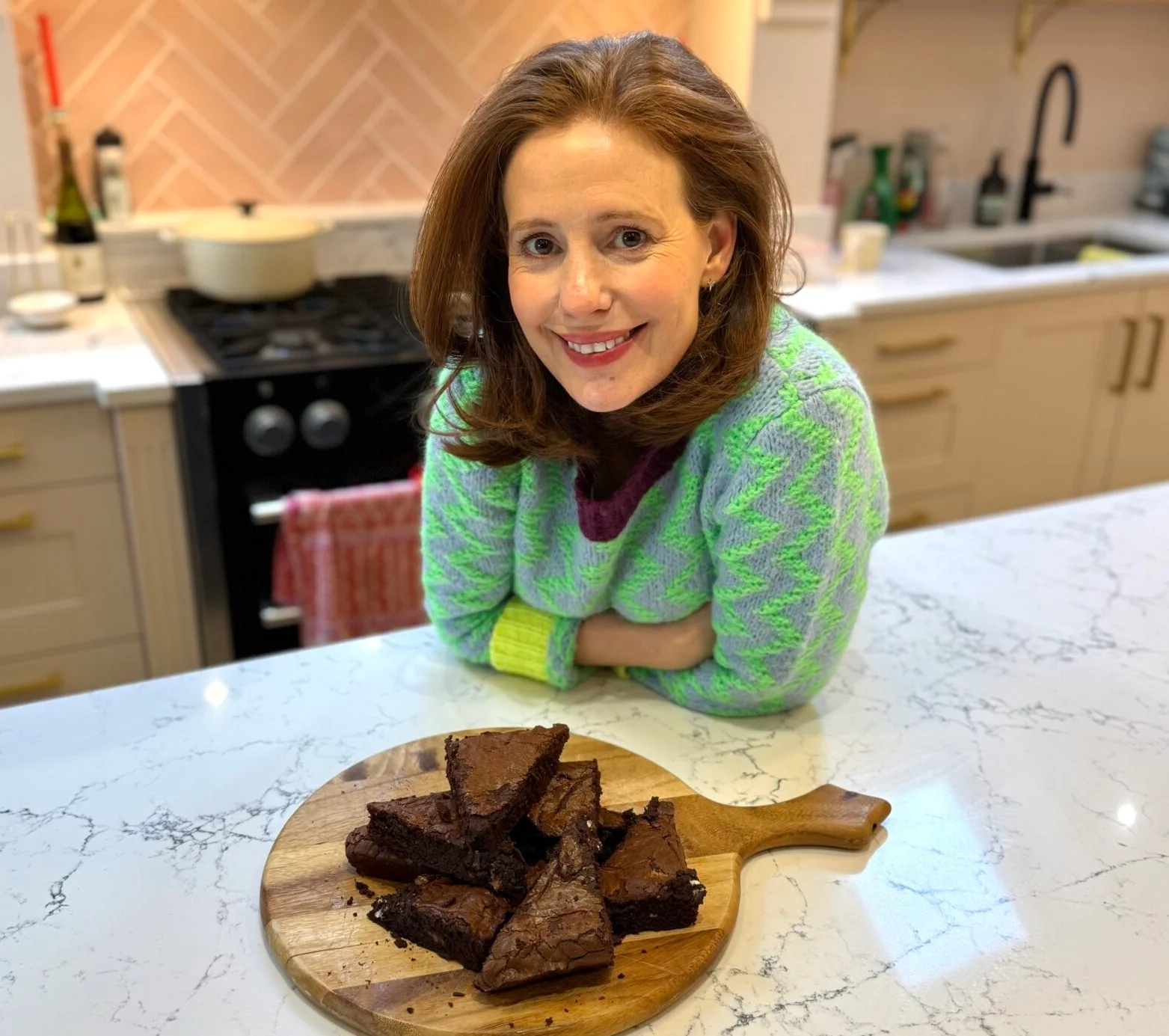 Amy Nuttall baking in her kitchen with plate of brownies