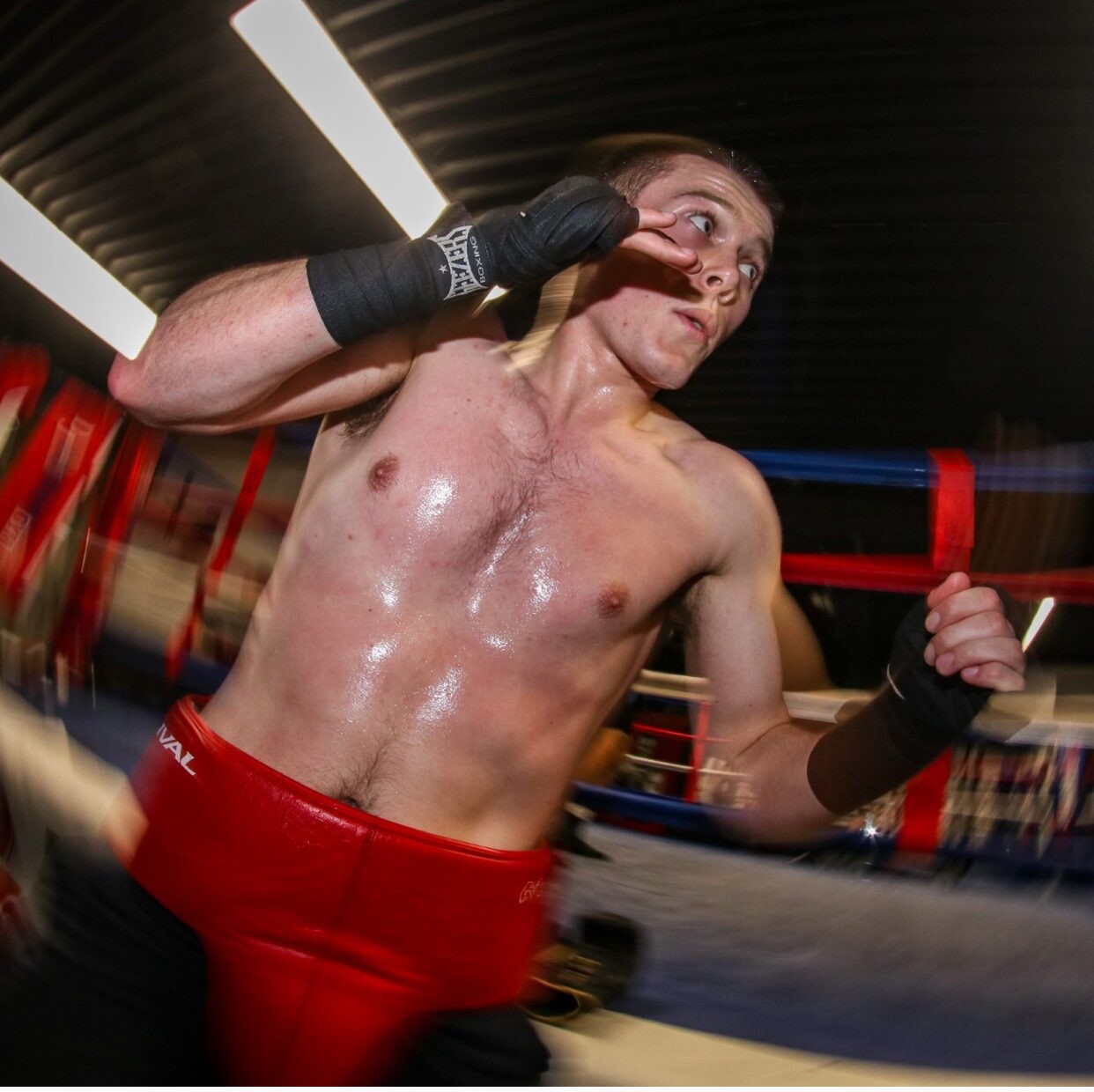 Ewan in a boxing pose with motion blur at the bottom of the photo