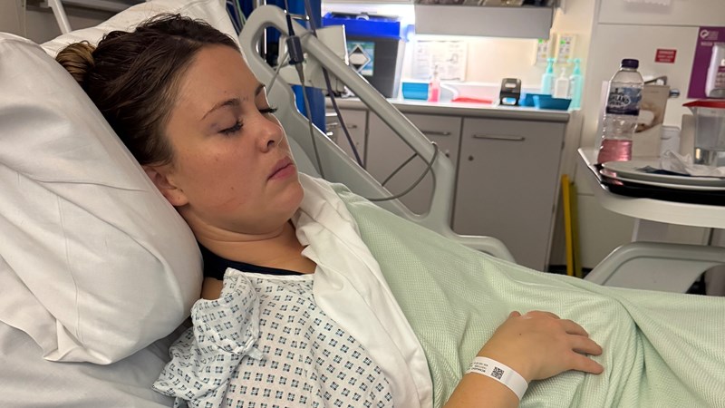 Hayley lies in a hospital bed