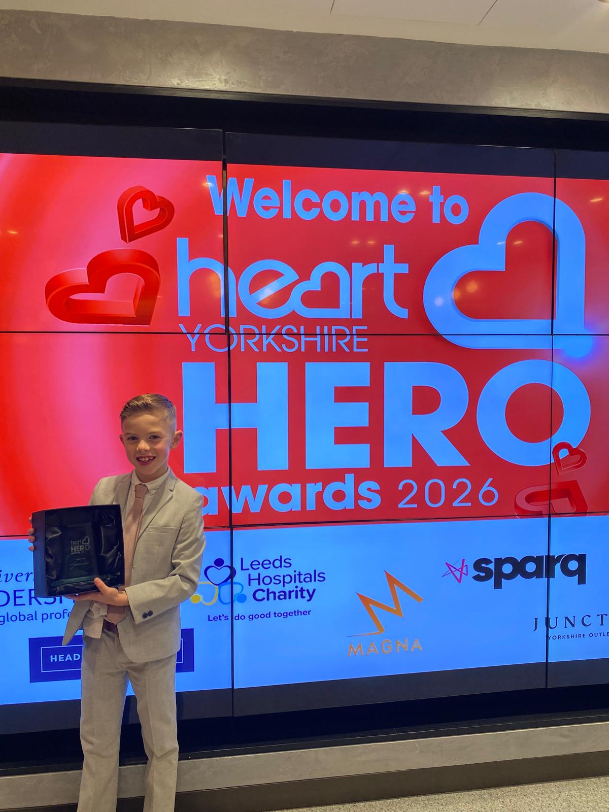 Oliver picks up an award for his running and fundraising challenges.