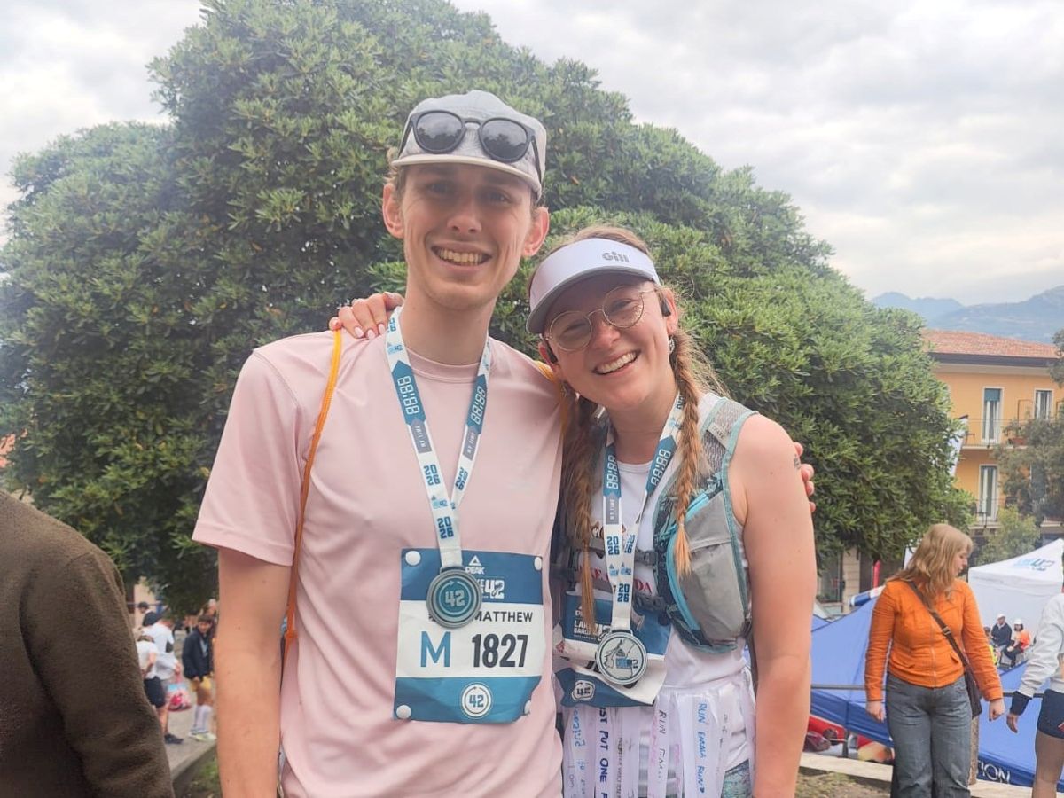 Emma and Matt wearing their medals after completing the Lake Garda Marathon