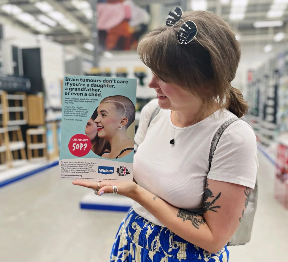 Grace Latter holding a poster in Wickes
