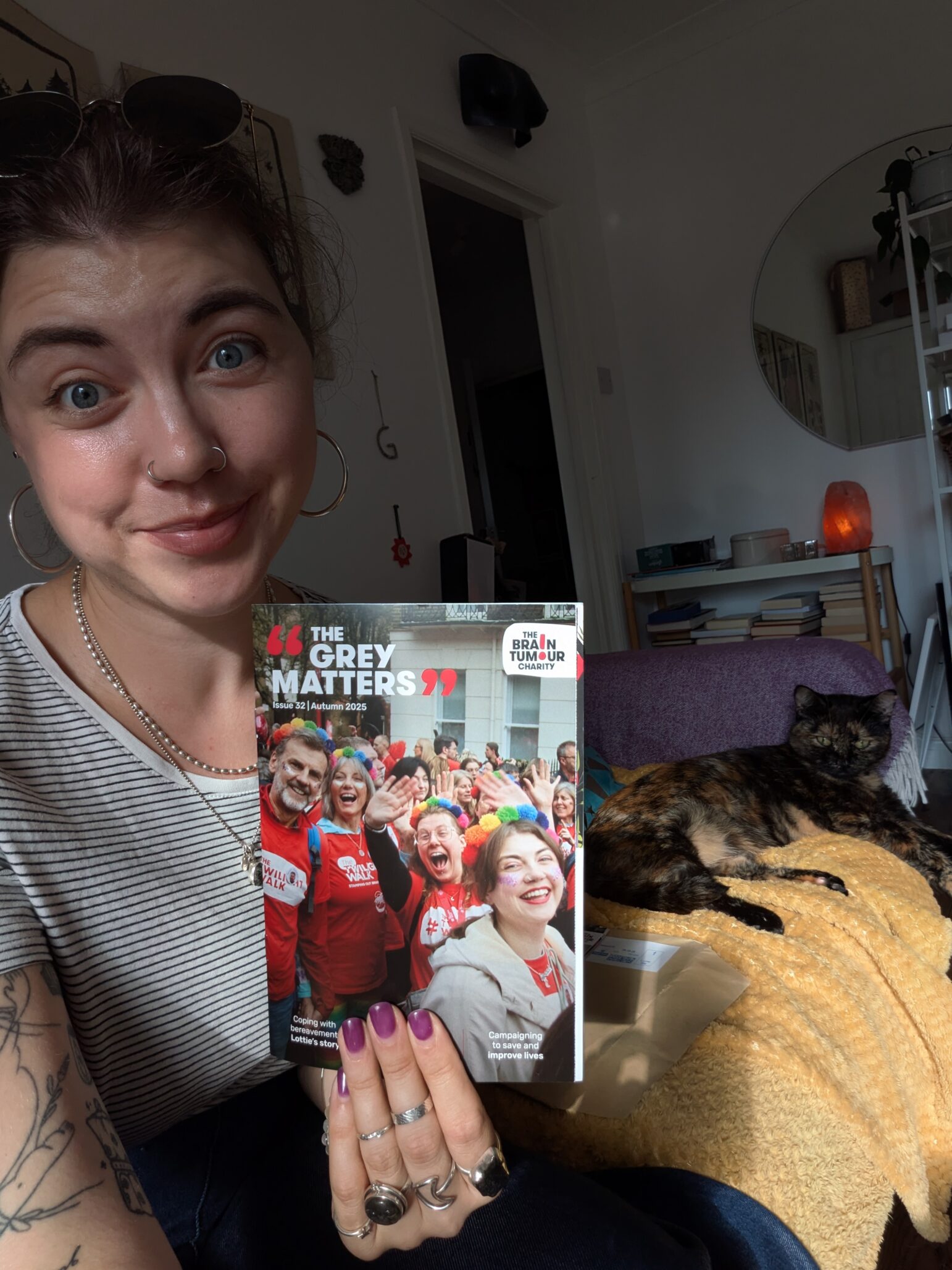 Grace Latter holding The Grey Matters, which features her on the cover
