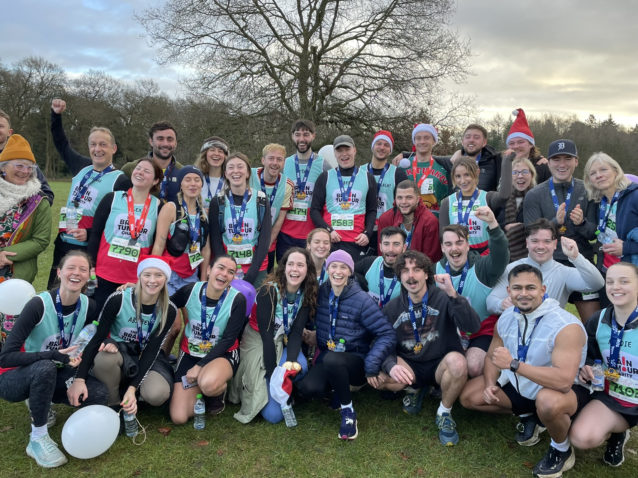 Rachel and her friends take a group shot in a field after running the Tatton 10k together