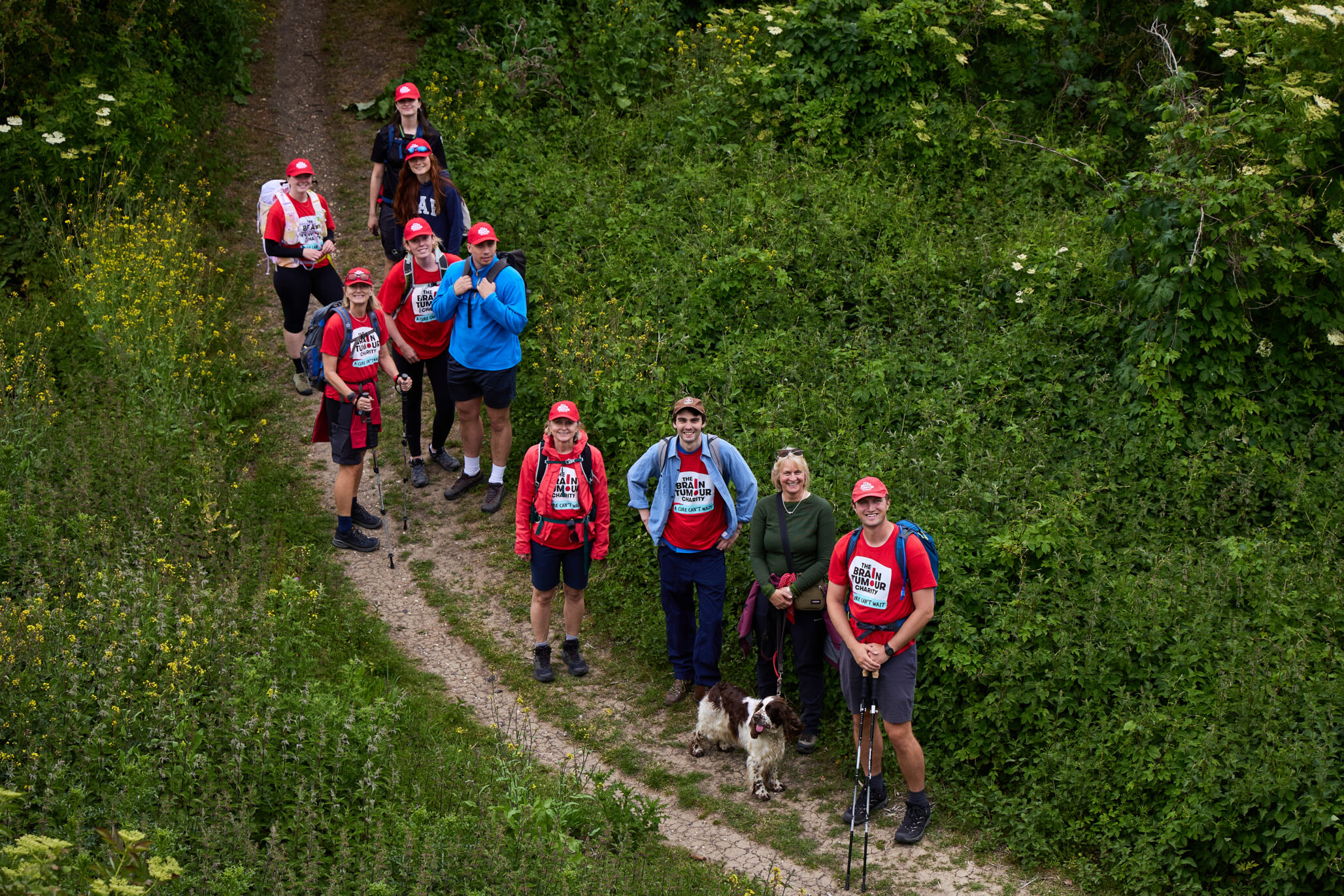 A group of walkers stand on the trail that runs the length of the Thames river