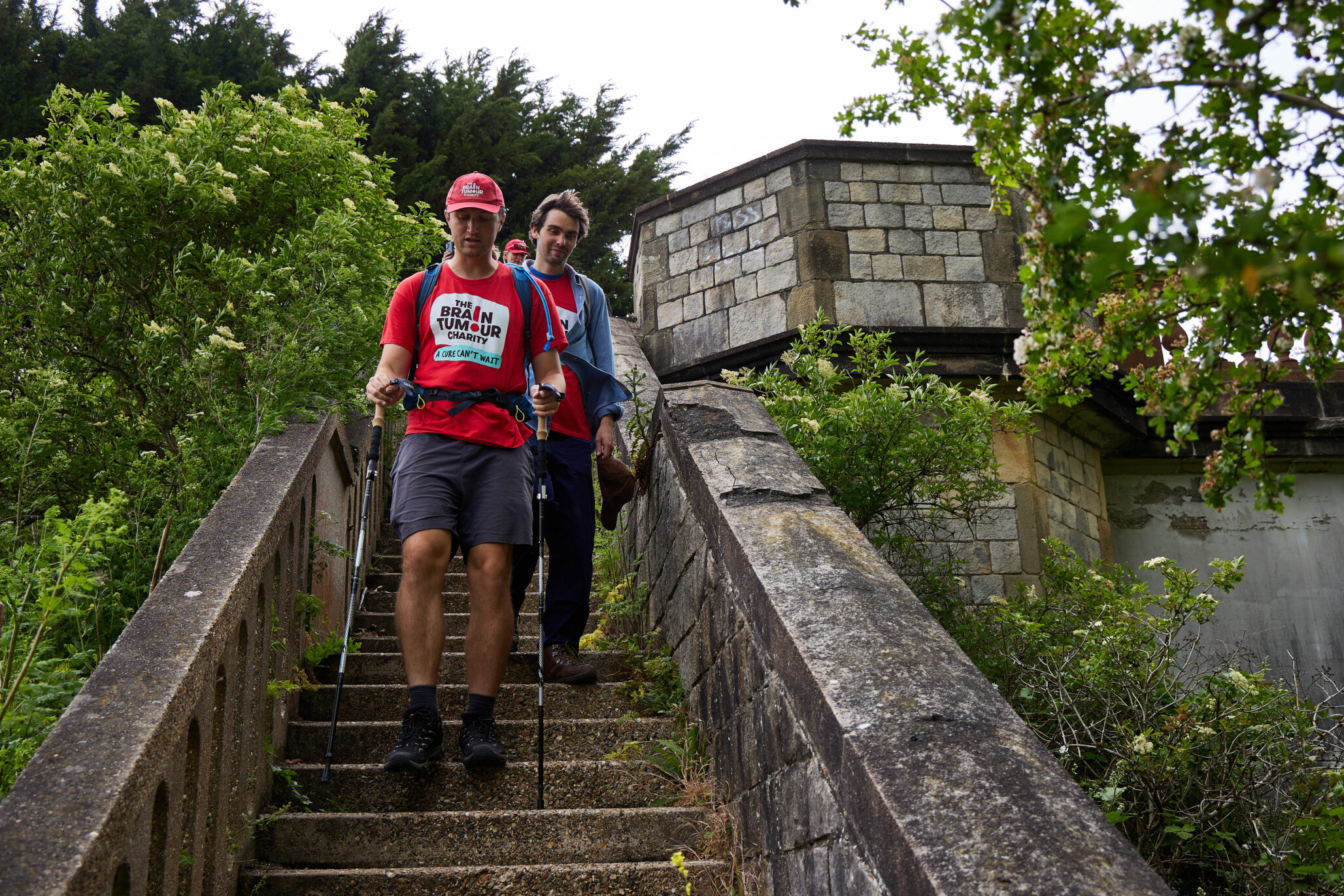 Two walkers make their way down a stone staircase