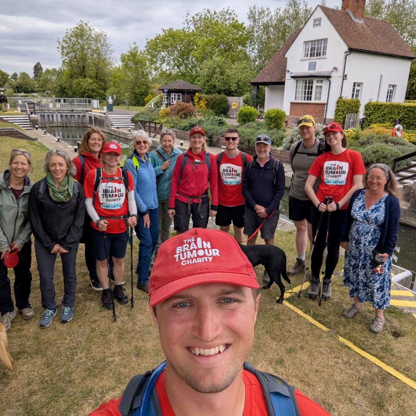 Jasper Dix, who is living with a malignant brain tumour, takes a photo with his walking group after completing the 185-mile Thames Path Walk on Monday 25th May