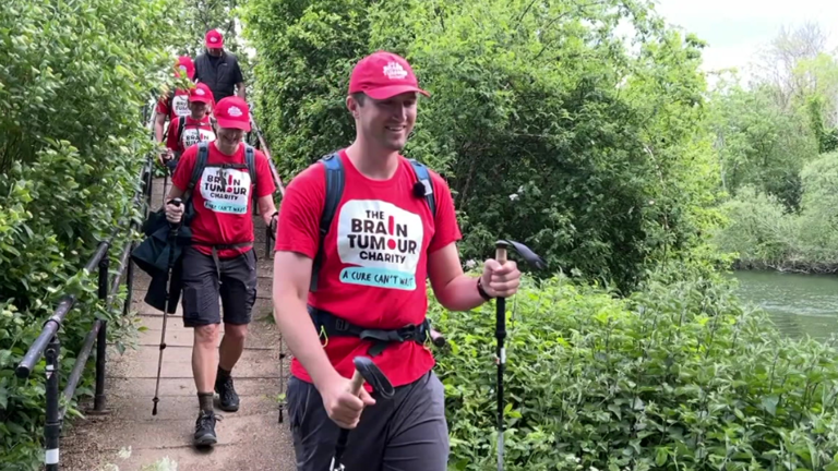 Jasper crosses a bridge with a series of walkers behind him on the Thames Path Walk
