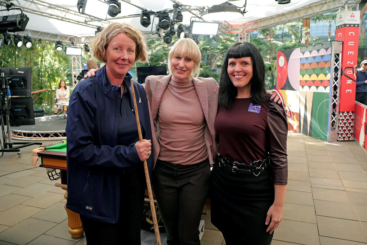 Three people from the EPSB stand in front of a snooker table