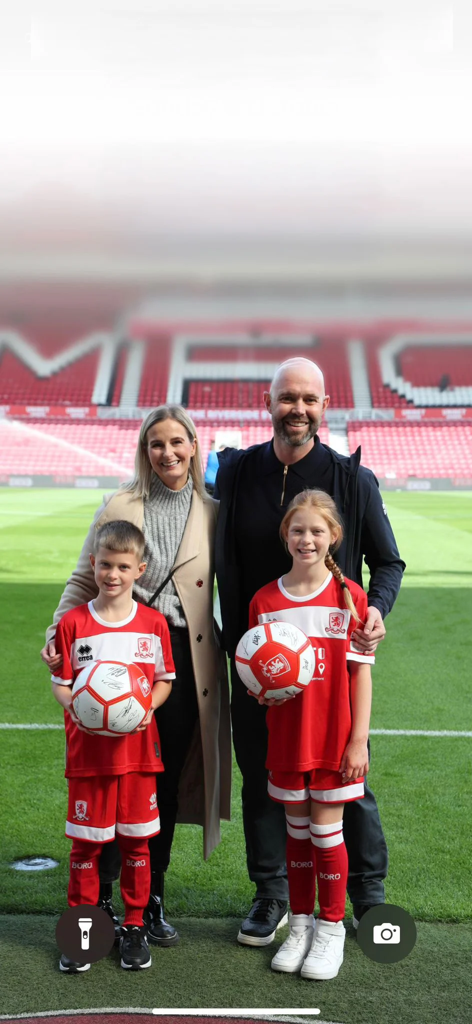 Sarah and family in a football stadium
