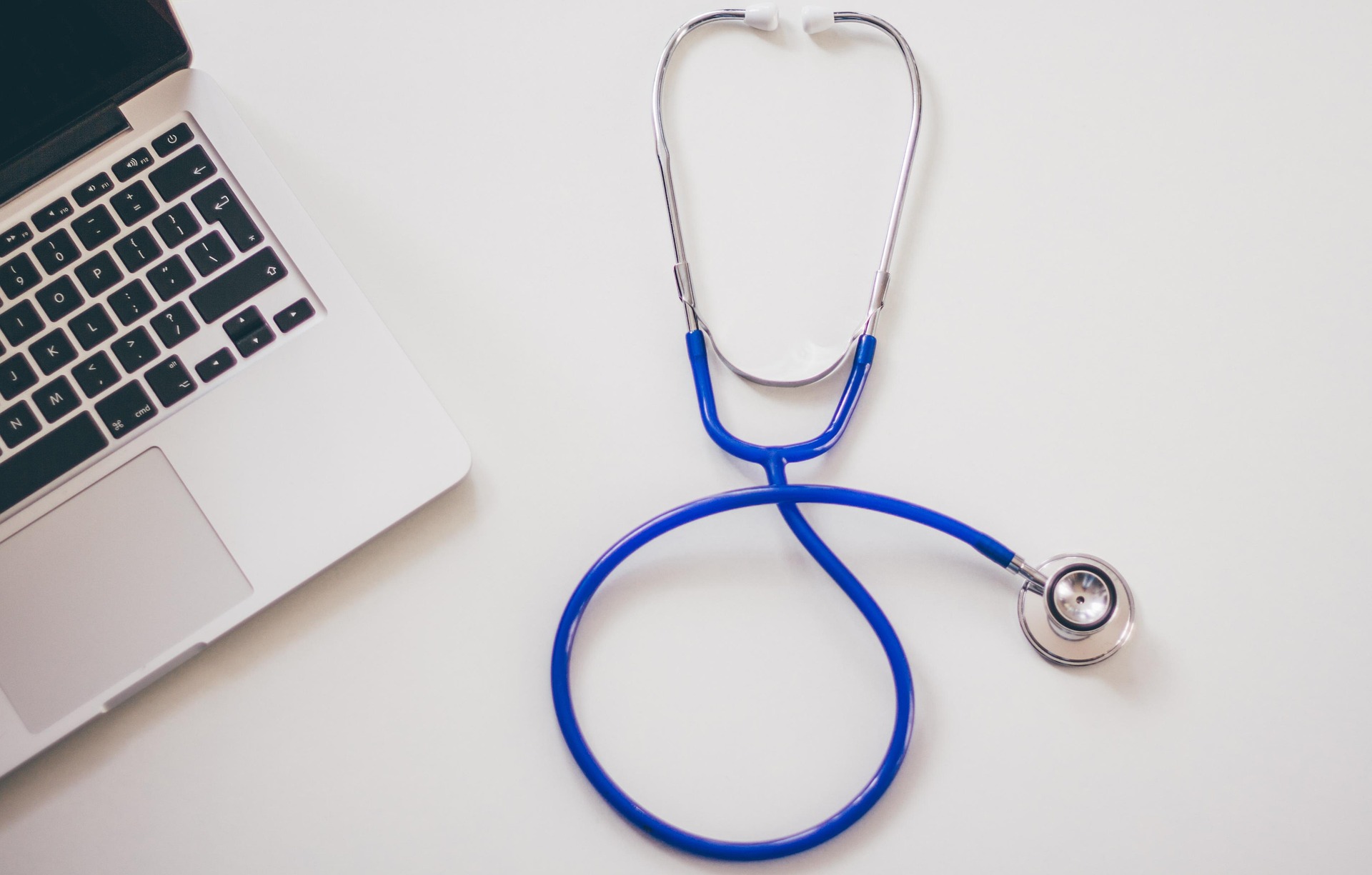A stethoscope next to a laptop, representing the online submission for ACT-BT - Access to Clinical Trials for Brain Tumours