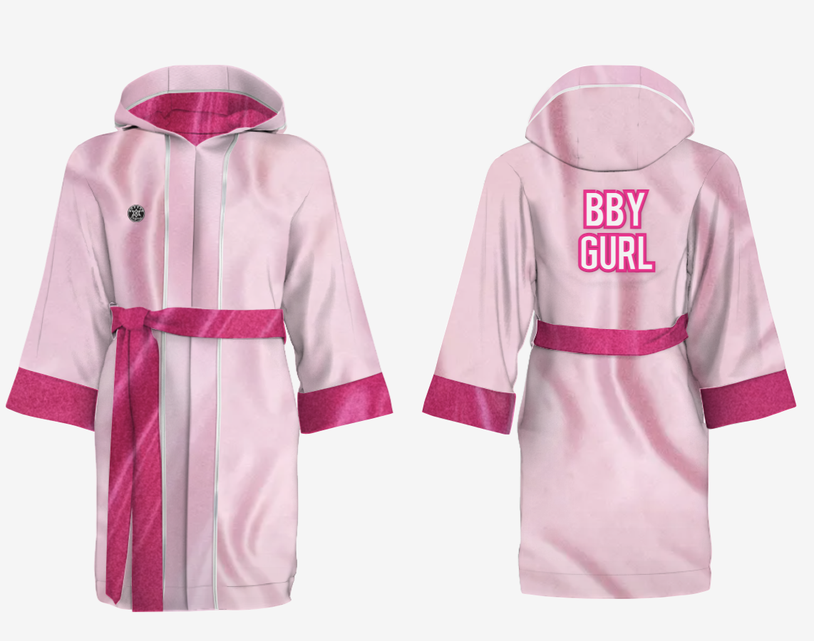 A pink boxing robe with the words "BBY GURL" printed on the back. This has been picked by for Hugo to wear during his boxing fundraiser in memory of his mum, Sophie Kinsella