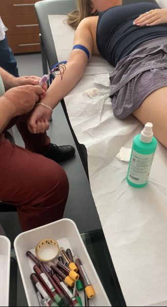 Annie lying in a hospital bed having blood tests