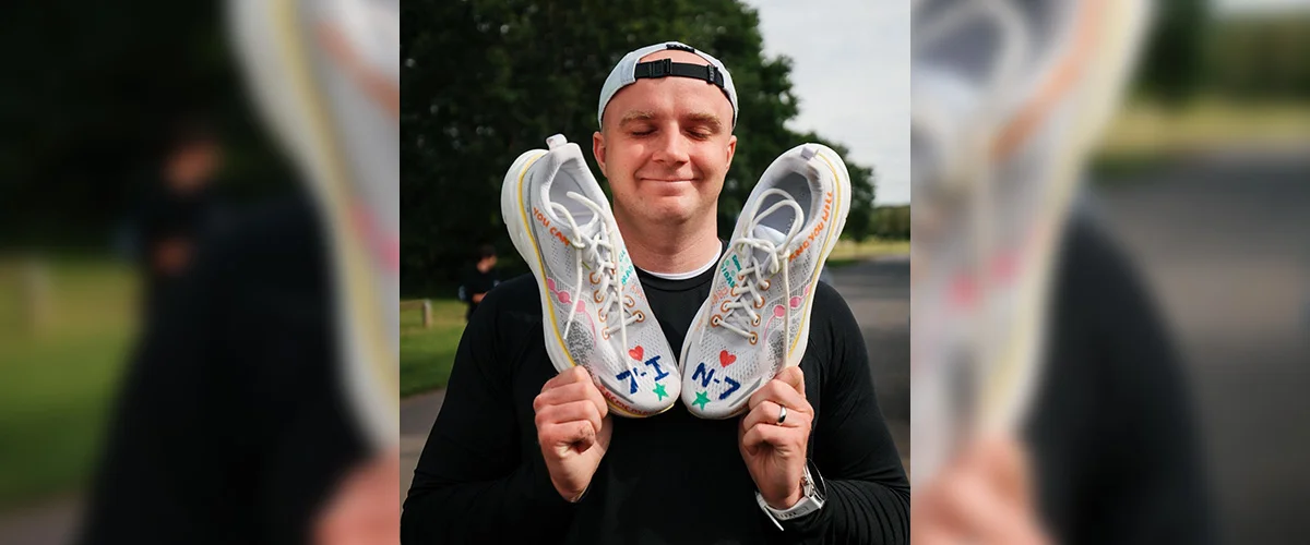 Bradley Ashman holding running shoes as he prepares to run 7 marathons in 7 days