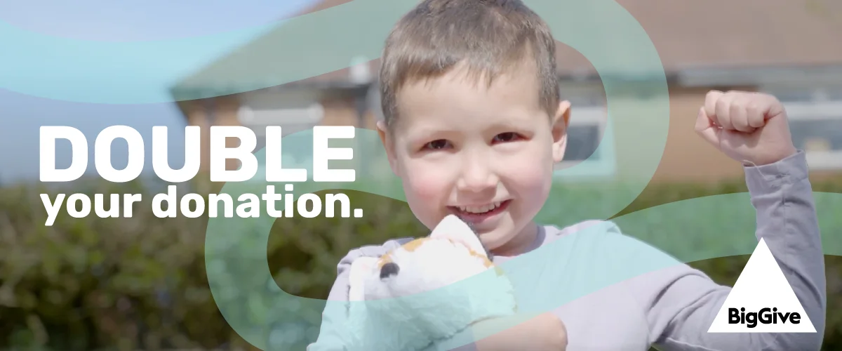A young boy holding his hand in the air with wording that reads: Double your donation
