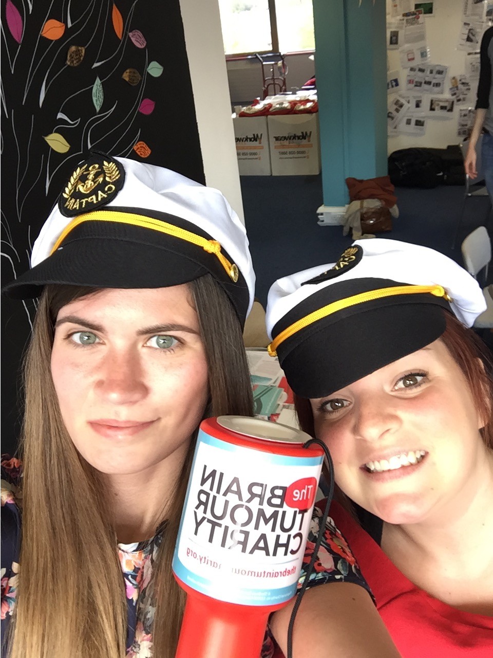 April and Emma wear sailor's hats and hold a collection tin for The Brain Tumour Charity. Their friendship started when they were Young Ambassadors