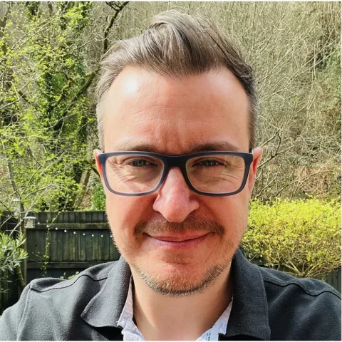 Close-up of Dr Mathew Clement standing outdoors