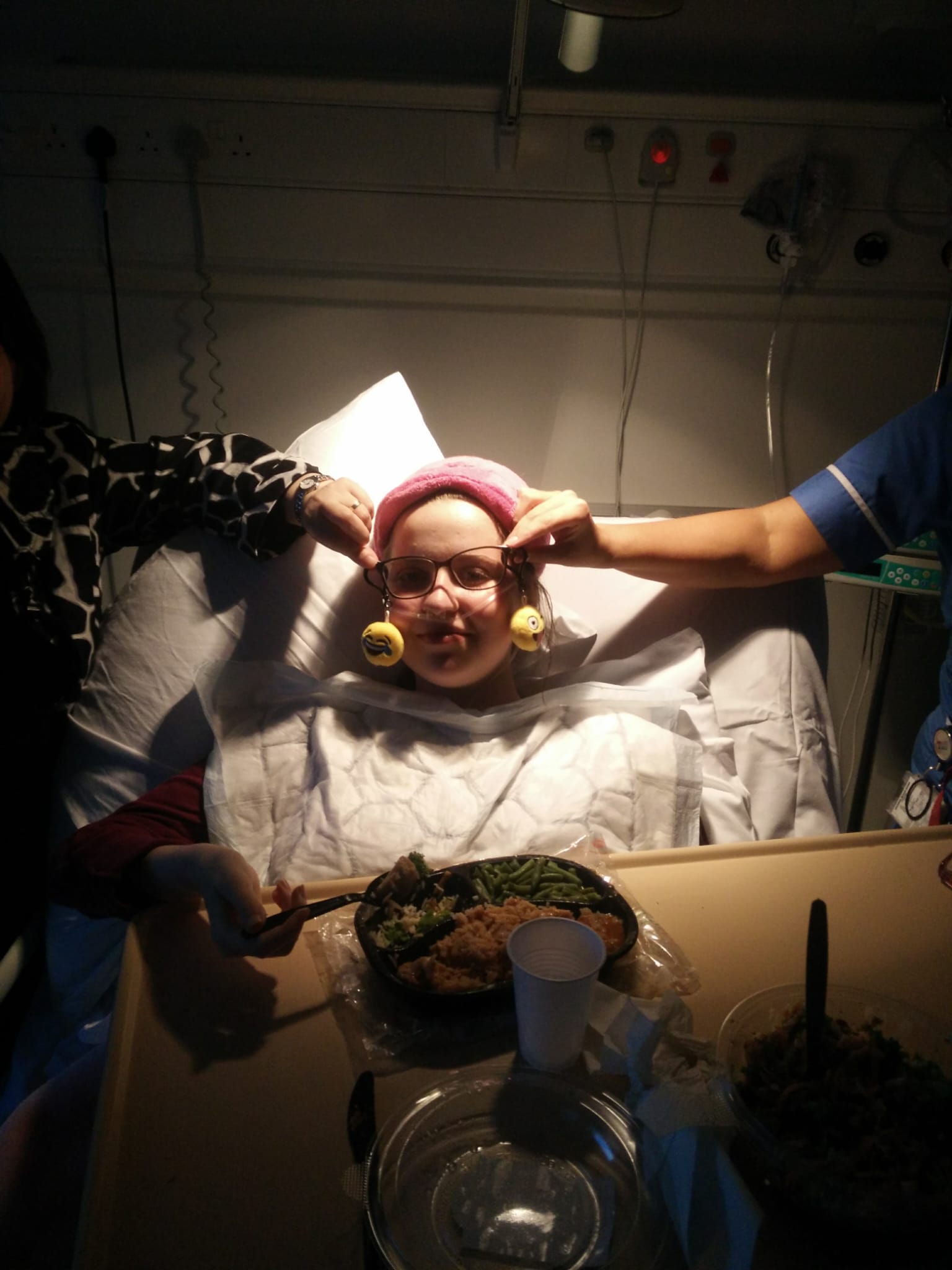 Rachel in hospital trying on some joke earrings